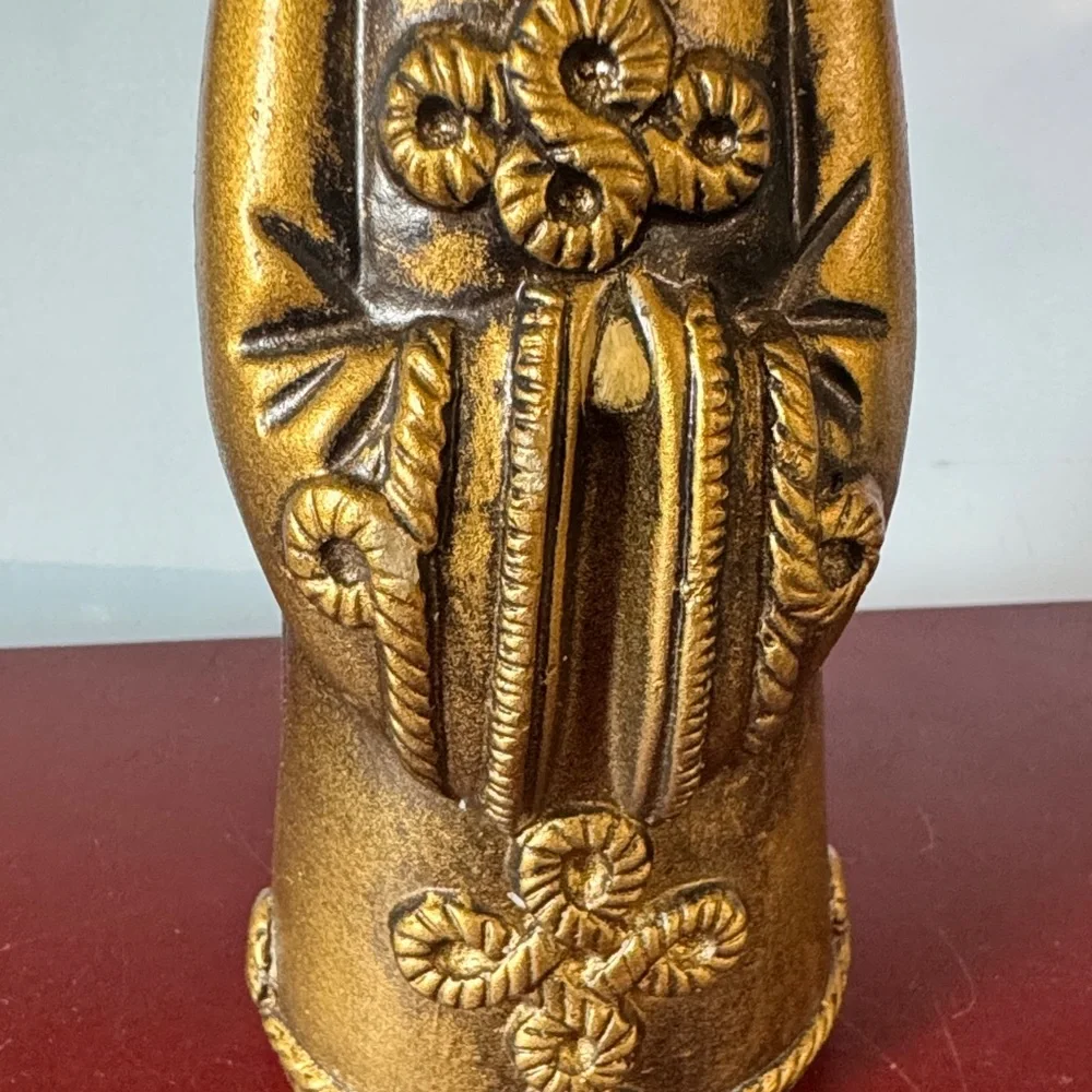 vintage chalkware candle holder featuring a metallic gold-finished figure